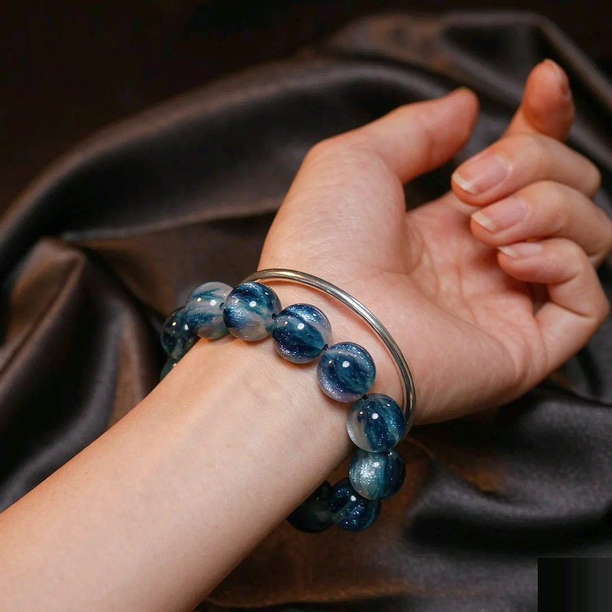 BEADORO Bluesand 20 mm resin beaded bracelet - worn on a wrist